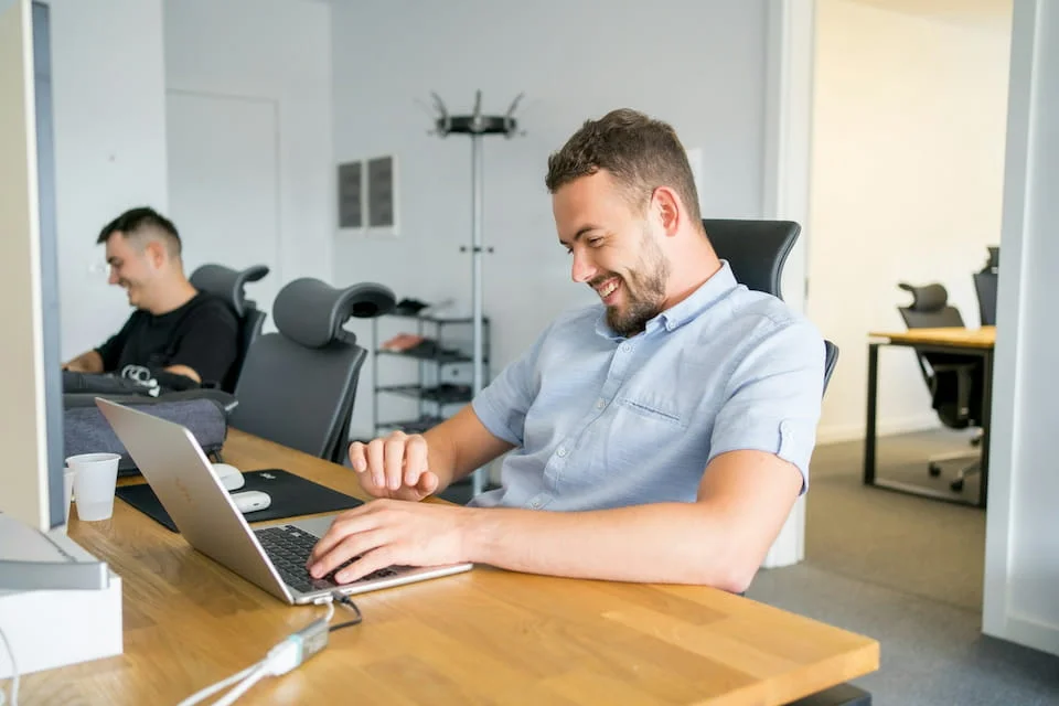 A man sitting in front of a laptop